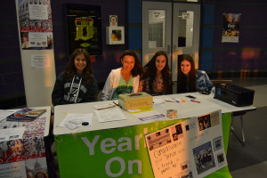 Students working at the yearbook booth on open house night.