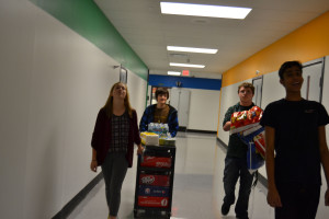 From right to left: Anna Ringuette (11th), Seth Oldenburg (11th), Douglas Husic (12th) and Neil Haran (10th) bring concessions down to the lunchroom 