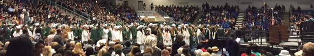 Seniors stand up for the start of the ceremony