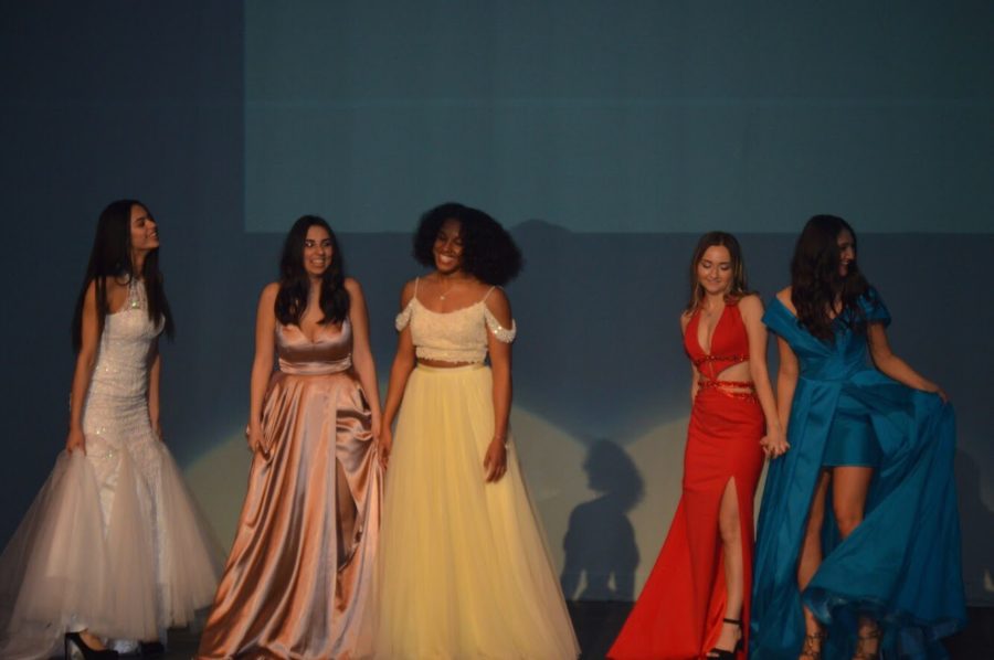 Fashion students modeling prom dresses from Hermz Boutique. 