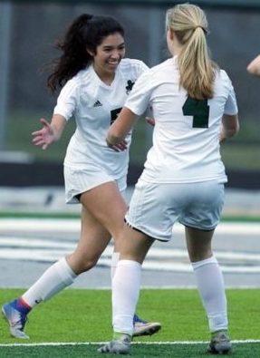 Senior Emily Falkowski (Left) congratulates sophomore Chloe Barnthouse (Right) after a great play against Clawson High School on April 23, 2018.