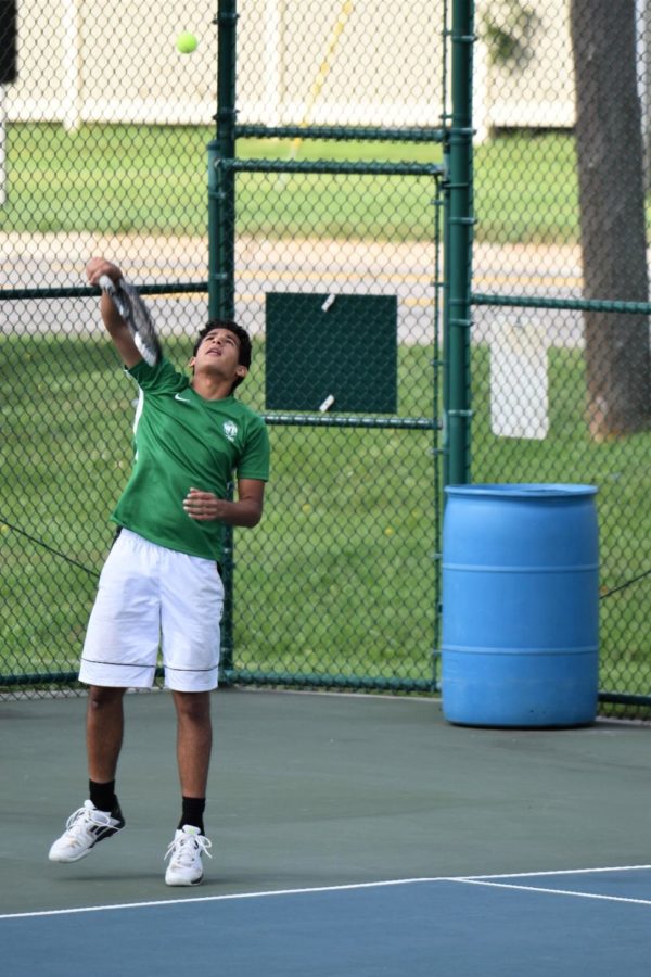 Senior Ali Hakim hitting a serve. Photo courtesy of West Bloomfield Athletics.